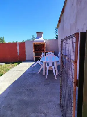 a table and chairs sitting on a patio at CASA DE CAMPO TRANQUILA EN VILAR CERCA DE SANTIAGO in Touro