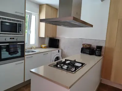 a kitchen with a stove top oven next to a sink at CASA DE CAMPO TRANQUILA EN VILAR CERCA DE SANTIAGO in Touro