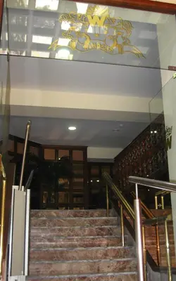 a set of stairs in a building with a chandelier at Hotel Windsor in Santiago de Compostela