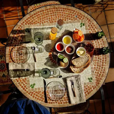 a table with bowls of eggs and bread on it at Hostal Pension Artilleiro in Santiago de Compostela