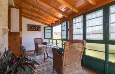 a living room with a staircase and a dresser in a house at Casa de Marcelo in Padrón