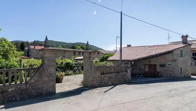 a garden with flowers in pots on a wall at Casa de Marcelo in Padrón