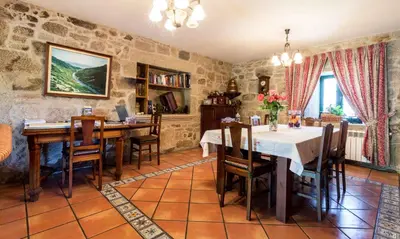 a dining room with a table and chairs at Casa de Marcelo in Padrón