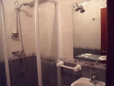 a bathroom with a shower and a sink at Hostal O Patron in Santiago de Compostela