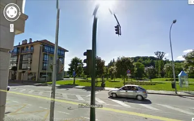 a car driving down a street with a traffic light at Hostal Pumar in Santiago de Compostela