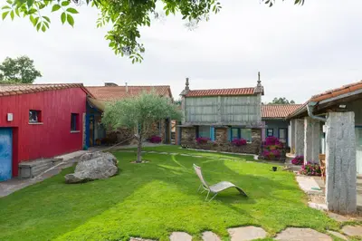 a lawn with a chair in the middle of a yard at Casa de Amancio in Lavacolla
