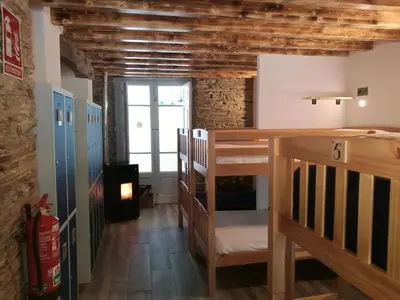 a room with two bunk beds and a window at Albergue Savior in Lourenzá