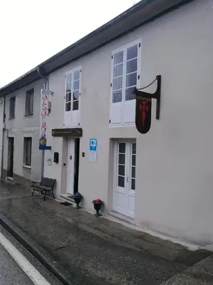 a white building with a sign on the side of it at Albergue Savior in Lourenzá