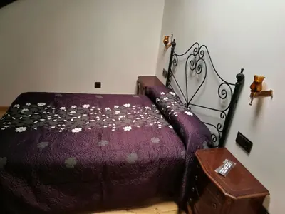 a bedroom with a bed with a purple comforter at Albergue Savior in Lourenzá