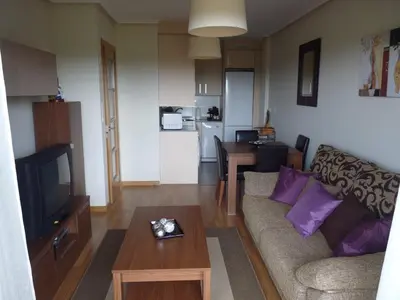a living room with a couch and a table at Precioso Apartamento con Spa en Galicia / Playa Catedrales in Foz