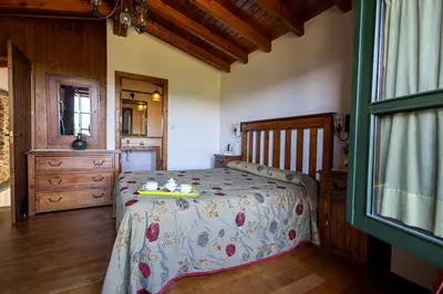 a bedroom with a bed with a tray on it at Naturlar Casa do Cura in Beigondo