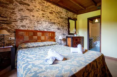 a bedroom with a large bed with pillows on it at Naturlar Don Benito in Arnego