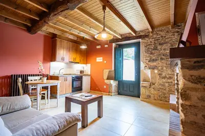 a living room with a couch and a table at Naturlar Don Benito in Arnego