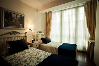 a hotel room with two beds and a window at Hotel Fonte de San Roque in Santiago de Compostela