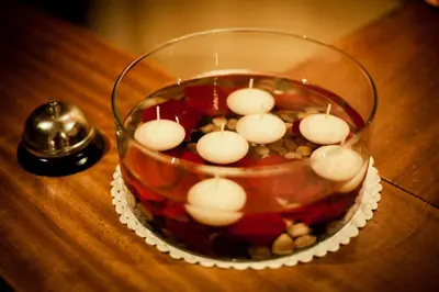 a glass vase with candles in it on a table at Hotel Fonte de San Roque in Santiago de Compostela