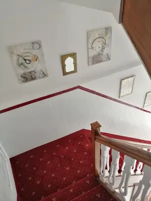 a staircase with a red carpet and a red stair case at Pensión Casa Frade in Arzúa