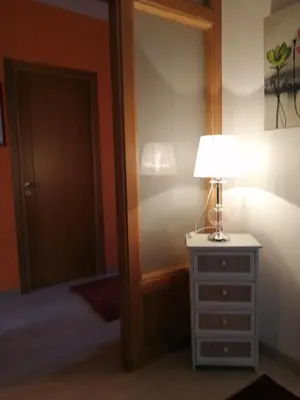 a lamp on a dresser next to a mirror at Pensión Casa Frade in Arzúa