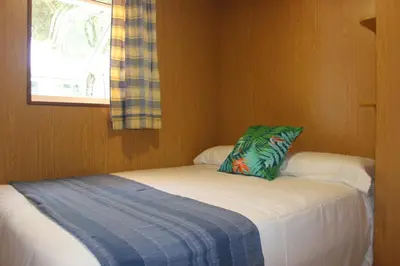 a small room with a bed with a pillow on it at Camping As Cancelas in Santiago de Compostela