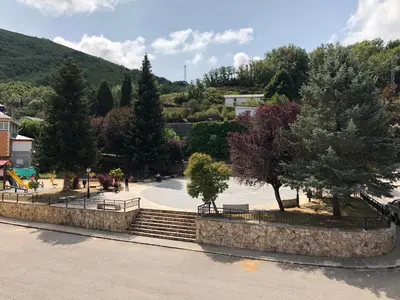 a set of stairs in a park with trees at Pensión Fernández in Vega de Valcarce