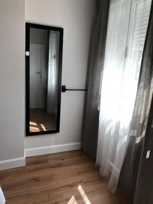 a mirror in the corner of a room with a window at Pensión Fernández in Vega de Valcarce