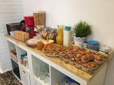 a counter with muffins and other food on it at Pensión Fernández in Vega de Valcarce