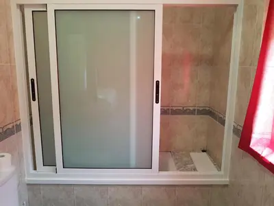 a white cabinet with glass doors in a bathroom at Pensión Garcia in Tríacastela