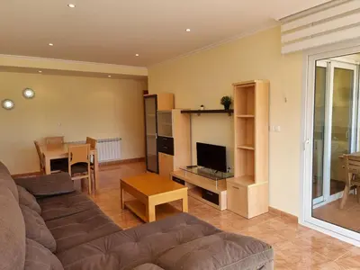 a living room with a couch and a table at Dúplex en 1ª línea de playa in Foz