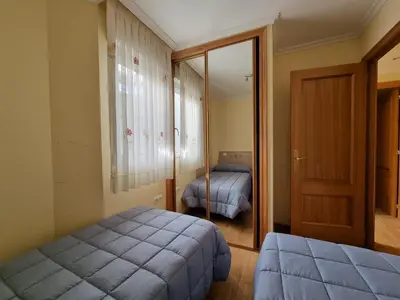 a bedroom with a bed and a mirror at Dúplex en 1ª línea de playa in Foz