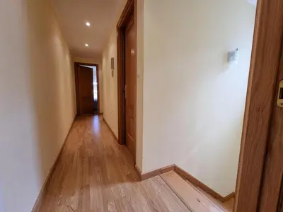 an empty hallway with wooden floors in a building at Dúplex en 1ª línea de playa in Foz