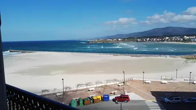 a view of a beach from a balcony at Dúplex en 1ª línea de playa in Foz