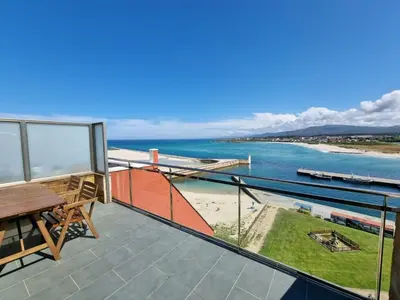 a balcony with a table and a view of the ocean at Mirador al Cantabrico in Foz