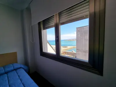 a window in a room with a view of the ocean at Mirador al Cantabrico in Foz