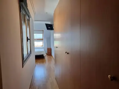 a hallway with a door and a room with a window at Mirador al Cantabrico in Foz