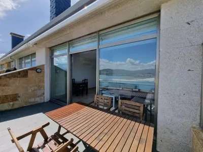 a balcony with a table and chairs and a view of the ocean at Mirador al Cantabrico in Foz