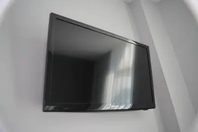 a flat screen tv hanging on a wall at Hotel Mica in Palas de Rei