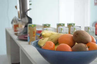 a blue bowl of fruit sitting on a counter at Hotel Mica in Palas de Rei