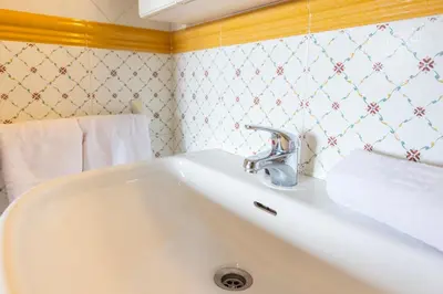 a bathroom with a white sink in a room at Apartagal-Edificio Celtas Foz in Foz