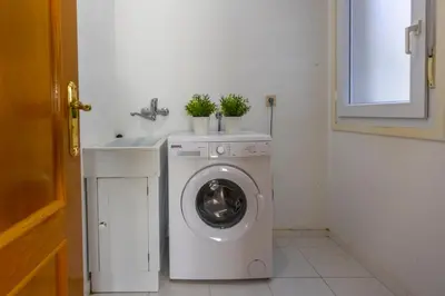 a washing machine in a bathroom next to a sink at Apartagal-Edificio Celtas Foz in Foz