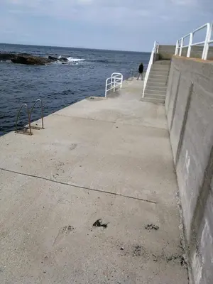 a person walking on a pier near the ocean at Chalet vacacional en segunda linea de playa in Foz