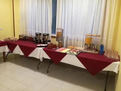 a long table with red and white table cloths at Hotel Suiza in Arzúa