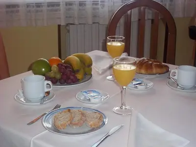 a table with plates of food and two glasses of orange juice at Hotel Suiza in Arzúa