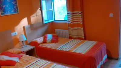 a bedroom with two beds and a window at pension compas in O Pedrouzo