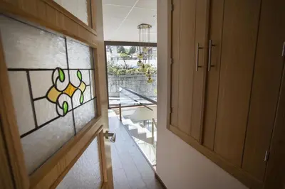 a door with a stained glass window in a hallway at Hotel Novoa in Sarria