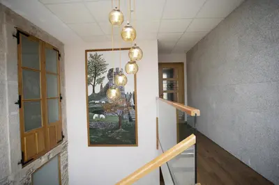 a hallway with a staircase with a painting on the wall at Hotel Novoa in Sarria