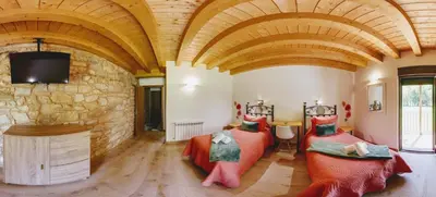 a large room with two beds and a tv at LA PANDELA in Las Herrerías