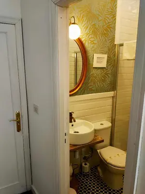 a bathroom with a sink and a toilet and a mirror at Casa castro in Cruces