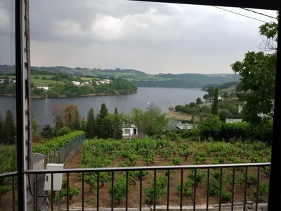 a view of a lake from a balcony at Casona da Ponte in Portomarin