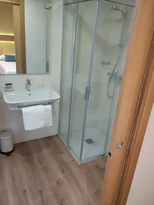 a bathroom with a shower and a sink at Casona da Ponte in Portomarin