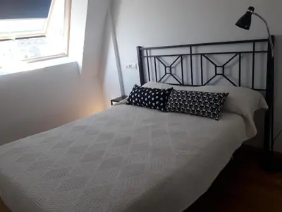 a bed with two pillows on it in a bedroom at Playa Caosa in San Ciprián