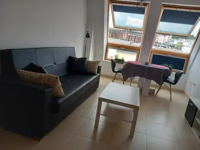 a living room with a couch and a table at Playa Caosa in San Ciprián